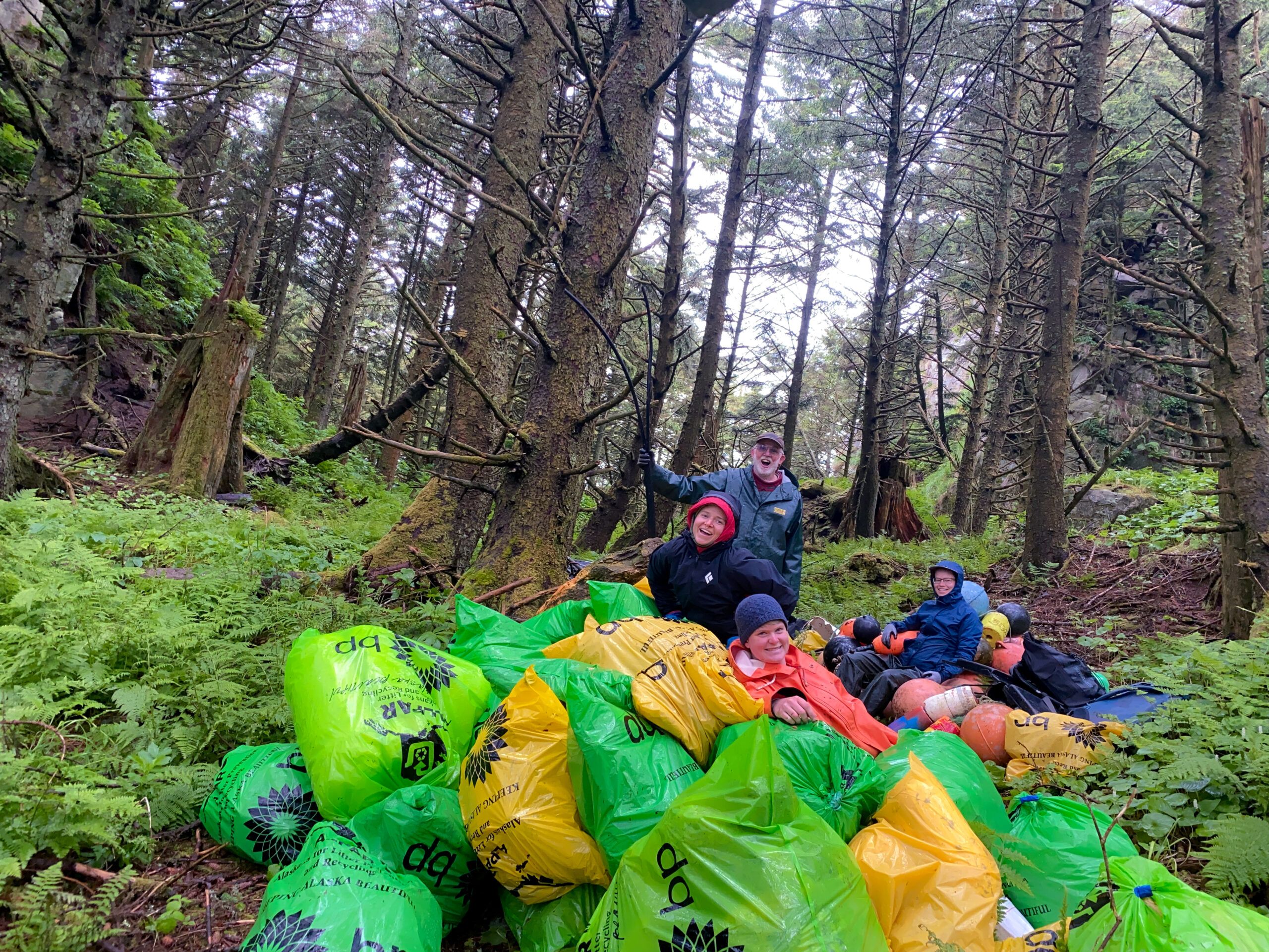 people piled on trash bags in woods