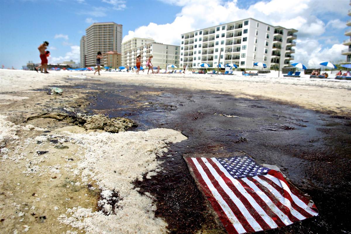 oil on beach USA flag