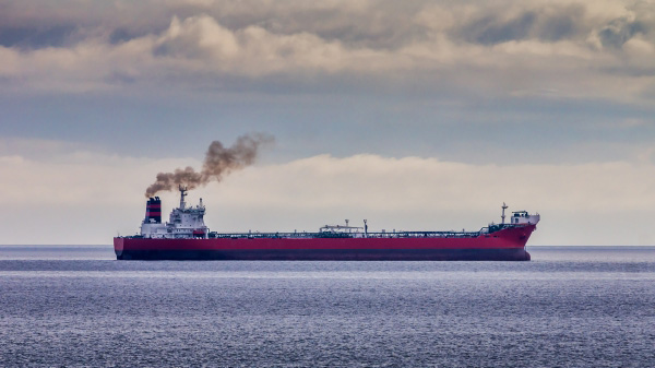 Oil tanker in the distance showing emissions.