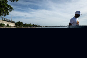 Man walking Playa Gringo beach during cleanup