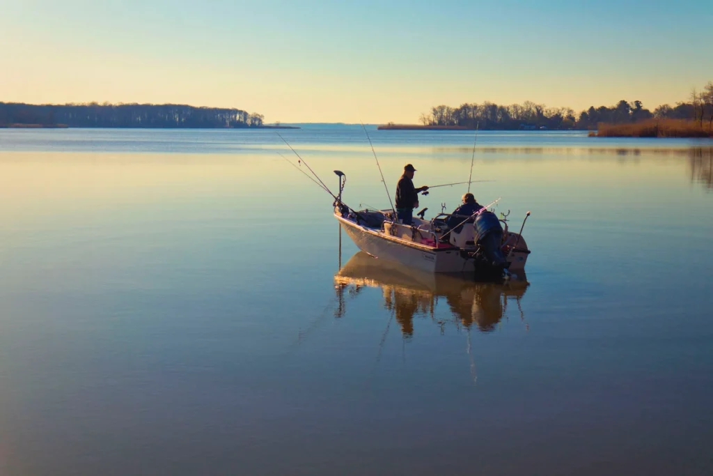 A person fishing on a small boat 