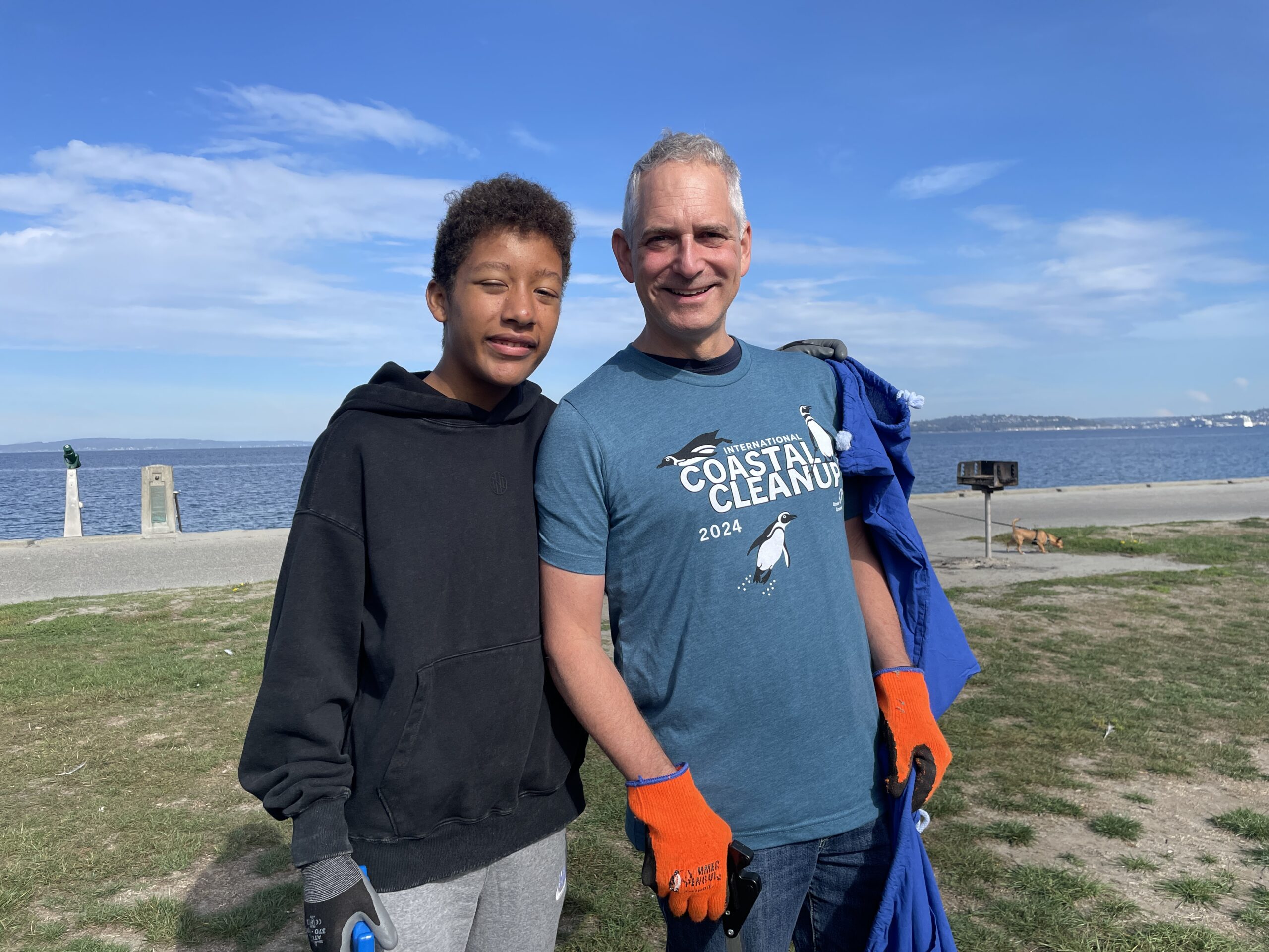 Volunteers pose on Alki Beach in Seattle during Ocean Conservancy's flagship ICC event on September 21, 2024.